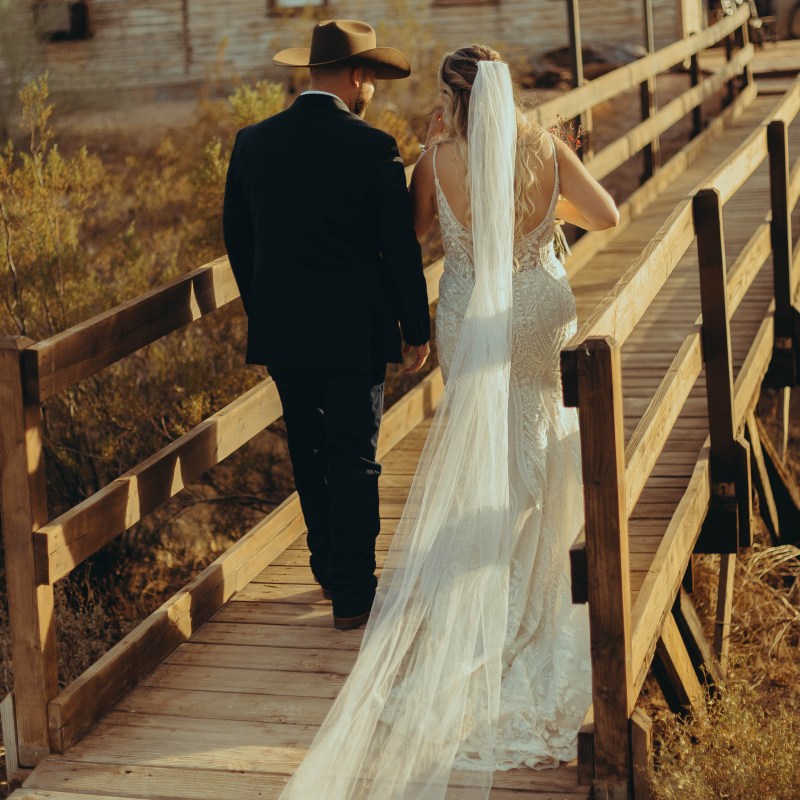 a man standing on top of a wooden bench