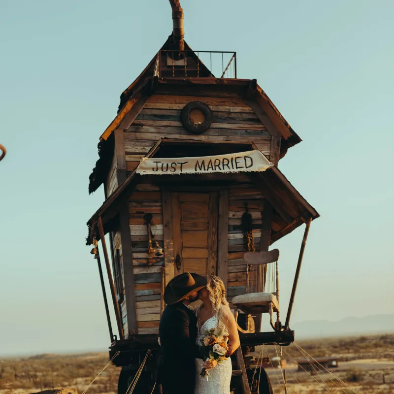 a fire hydrant on the side of a dirt field