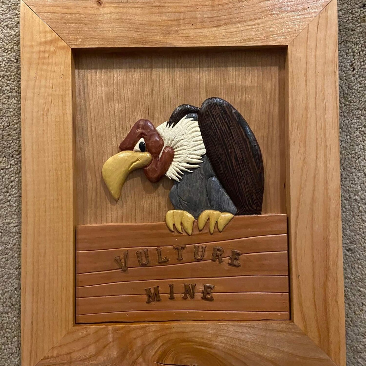 a bird sitting on top of a wooden box